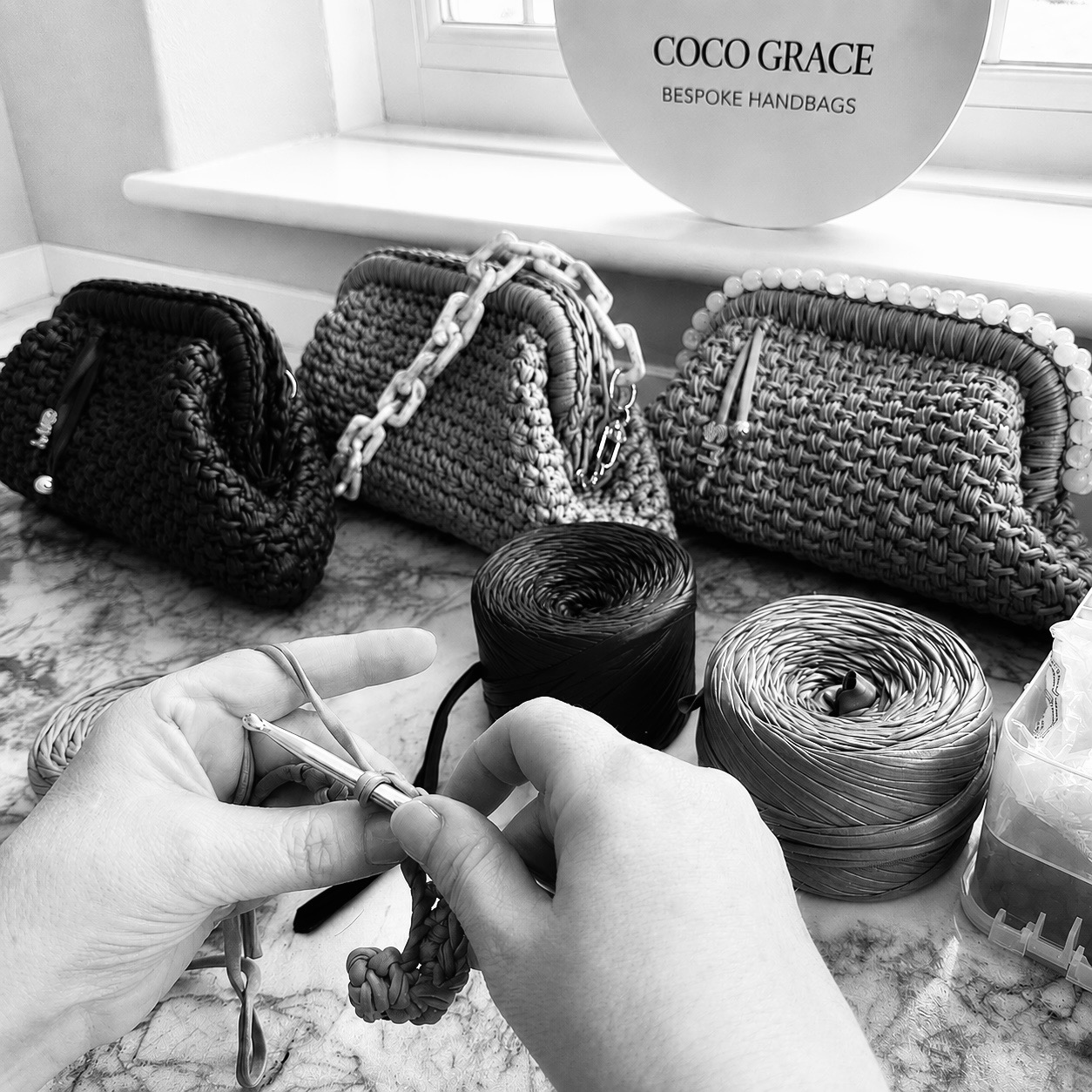 An artisan stitching leather in the atelier